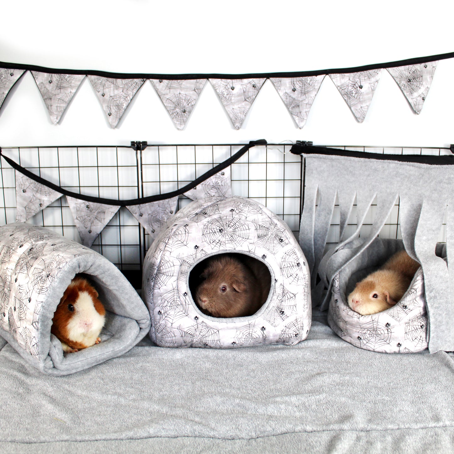 Halloween Spider Guinea Pig Accessory Bundle, Cuddle cup bed, Snuggle tunnel and hidey house in a full cage set up along with bunting and a corner fleece forest to make a halloween themed cage for guinea pigs