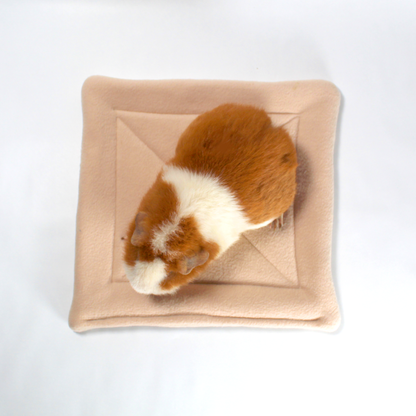 Large Beige Square Guinea Pig Pee Pad, overhead view with a guinea pig so you can see the saize of the pee mat