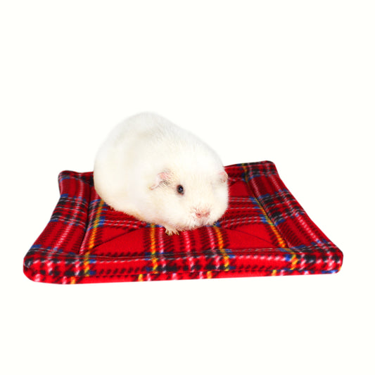 Large Red Tartan Guinea Pig Pee Pad, front view of the pee pad for guinea pigs with a cute guinea pig sat on it for size comparison