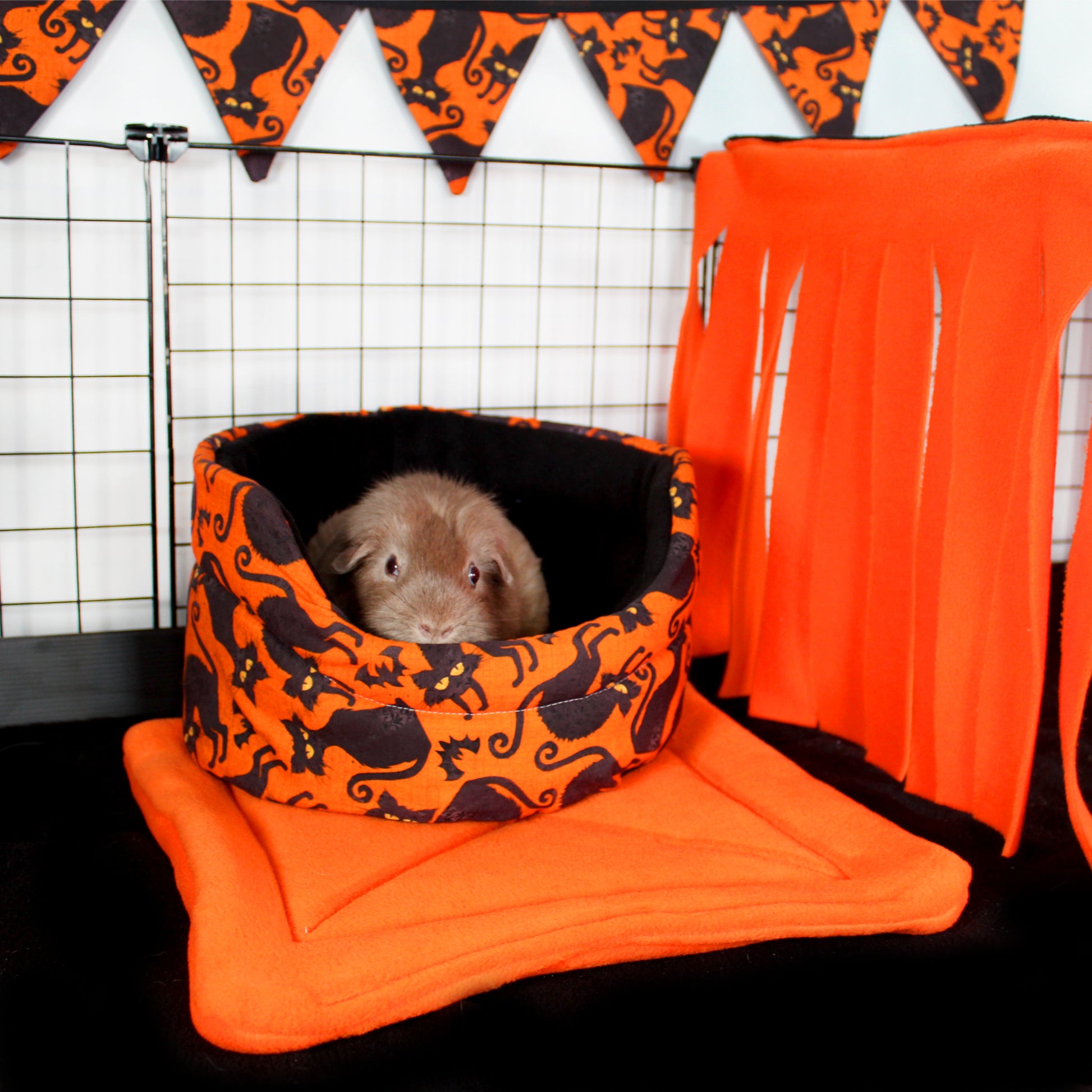 Orange and Black Large Fleece Forest, happy guinea pig enjoying a bed ned to the fleece forest