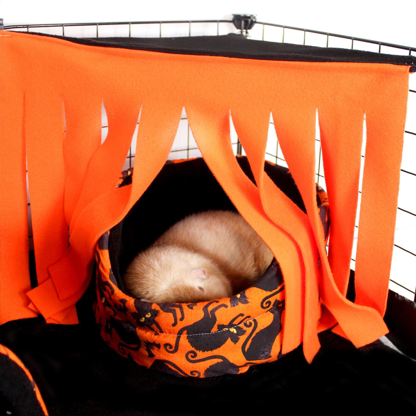 Black & Orange Corner Fleece Forest, image shows how to use the fleece forest to turn a bed for guinea pigs in to a cozy hideout