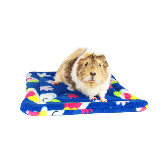 Large Unicorn Square Guinea Pig Pee Pad, front view of the guinea pig wee wee pad with a guinea sat on top for size comparison 