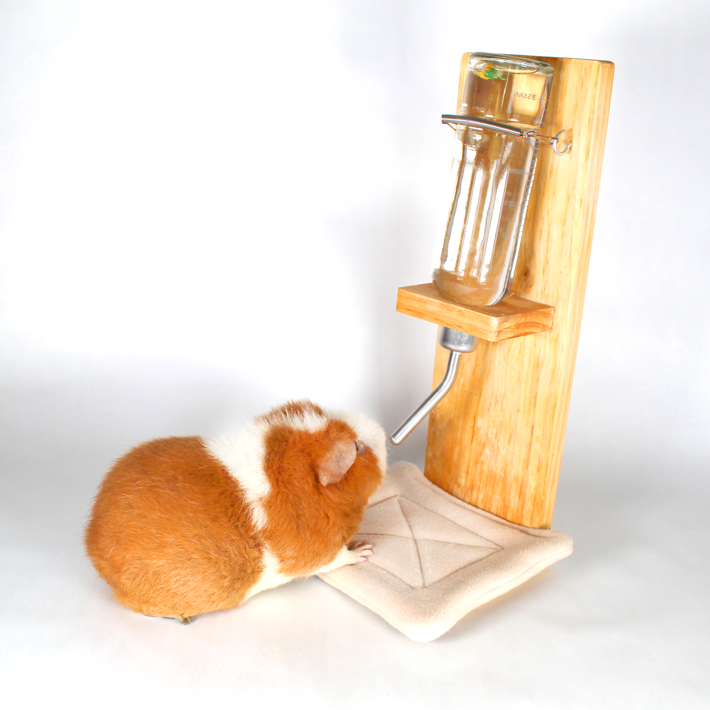 Pair Of Beige Water Bottle Drip Pads, drip pad under a water bottle with a happy guinea pig drinking