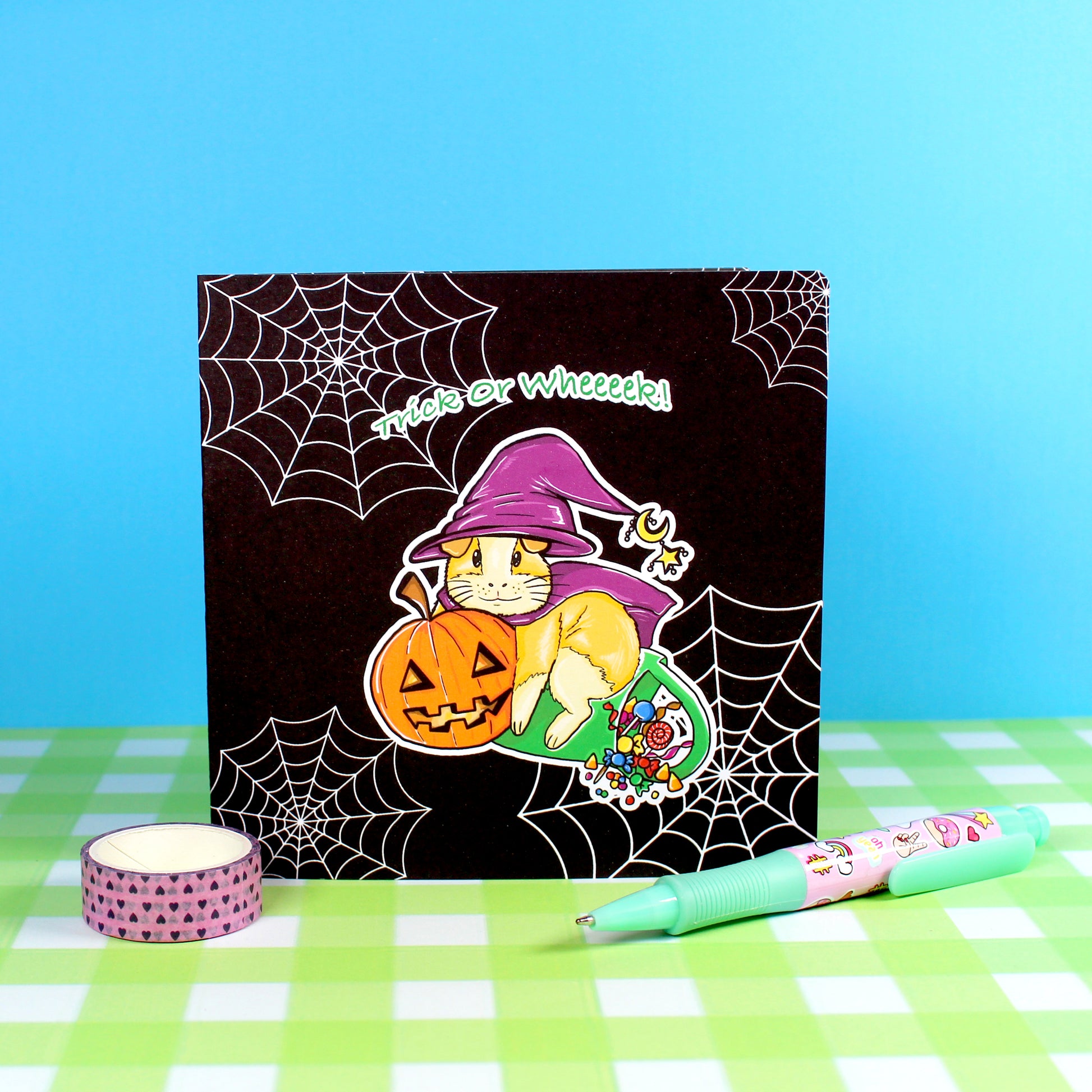 Halloween Guinea Pig Witch Greetings Card, black background of the happy Halloween card